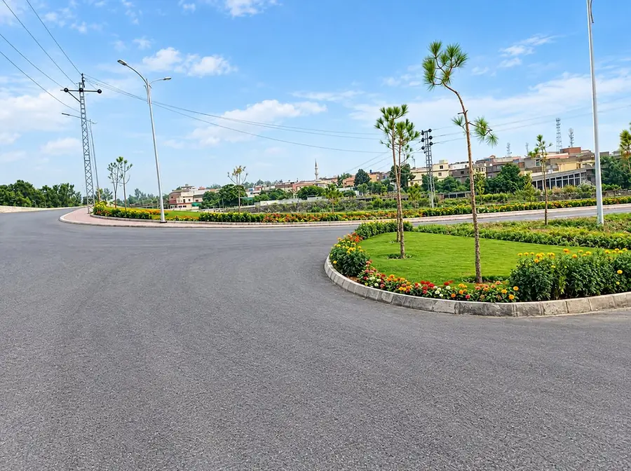 Road curve with island flower beds and pines